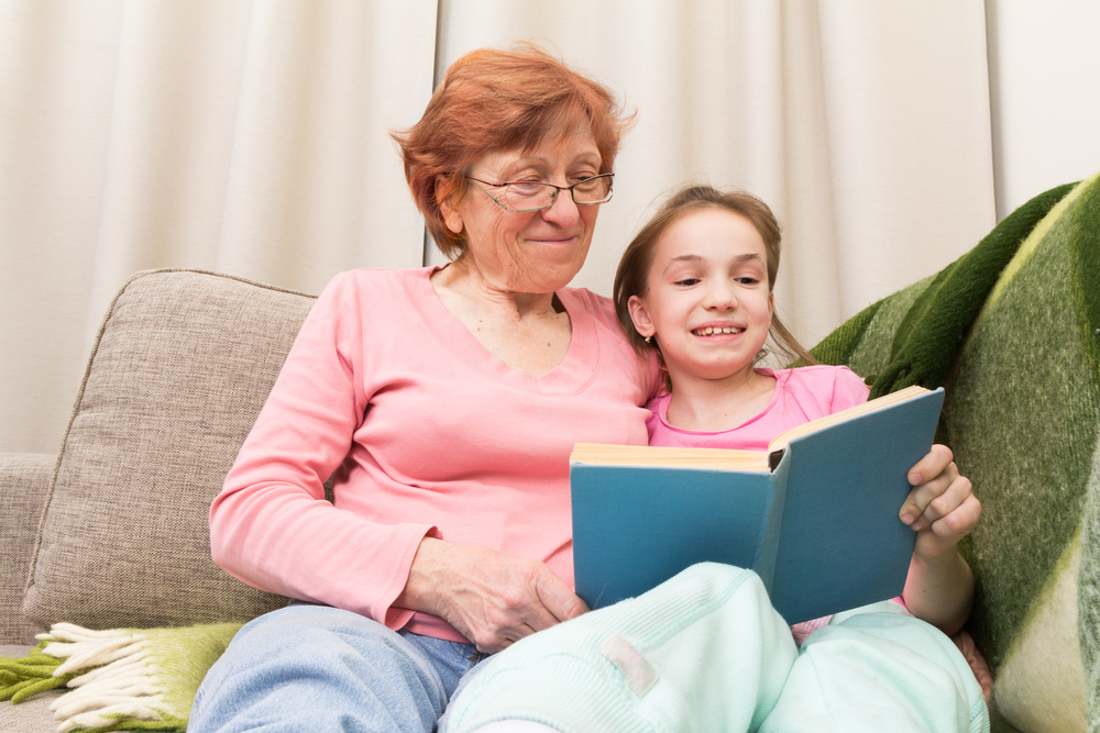 grandmother-and-child-reading-on-the-couch